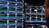 A trader works on the floor of the New York Stock Exchange (NYSE) at the opening bell in New York City on March 10, 2025. 