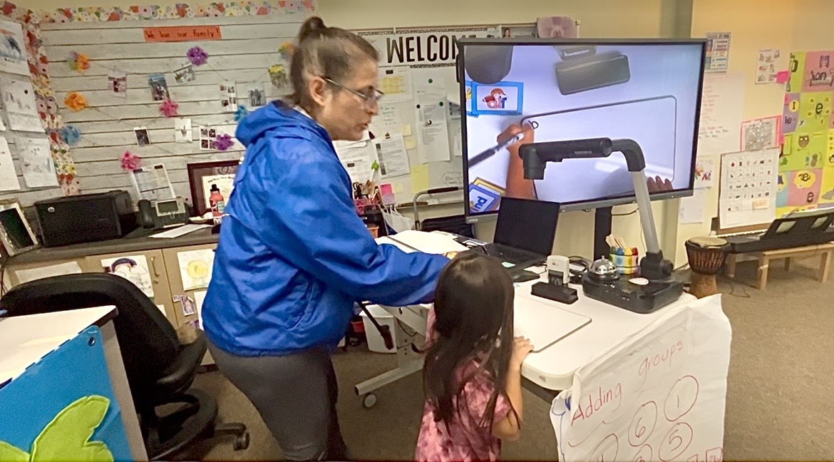 Maria Wong (left) with one of her students in her classroom at Salk Elementary in Mira Mesa, March 14, 2025.