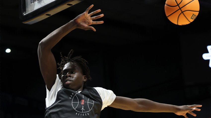 Mar 17, 2025; Dayton, OH, USA; San Diego State Aztecs forward Magoon Gwath (0) dunks during the First Four Practice at UD Arena.