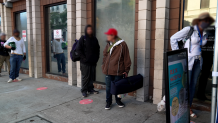 Benefit receivers are waiting in line in a district in downtown San Diego.