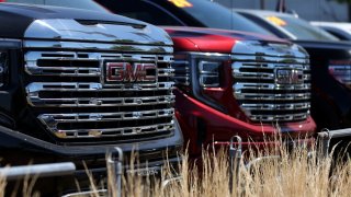 Brand new GMC trucks are displayed on the sales lot at Hanlees Hilltop GMC on July 02, 2024 in Richmond, California.