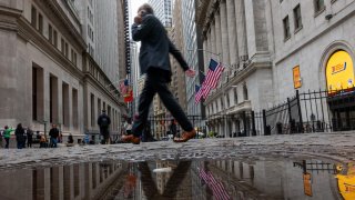 People walk by the New York Stock Exchange  on April 4, 2025 in New York City. 