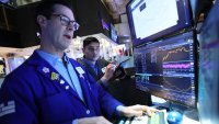 Traders work on the floor of the New York Stock Exchange during morning trading on April 22, 2025 in New York City.