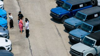 In an aerial view, Ford Broncos are seen for sale on a lot at a dealership on April 18, 2025 in Austin, Texas.