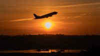 An airplane lifts off from Ronald Reagan Washington National Airport as the sun rises Monday, Feb. 3, 2025, in Arlington, Va.
