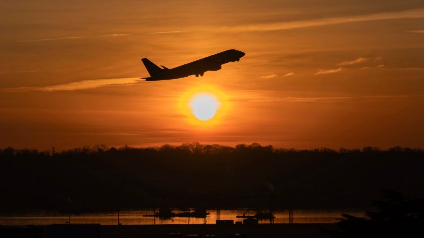 An airplane lifts off from Ronald Reagan Washington National Airport as the sun rises Monday, Feb. 3, 2025, in Arlington, Va.