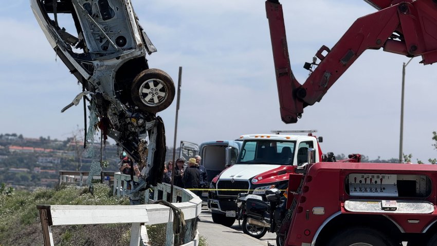 Around noon, a tow crew managed to pull the battered white Toyota from the sea.