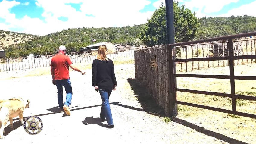 A man walking around a ranch.