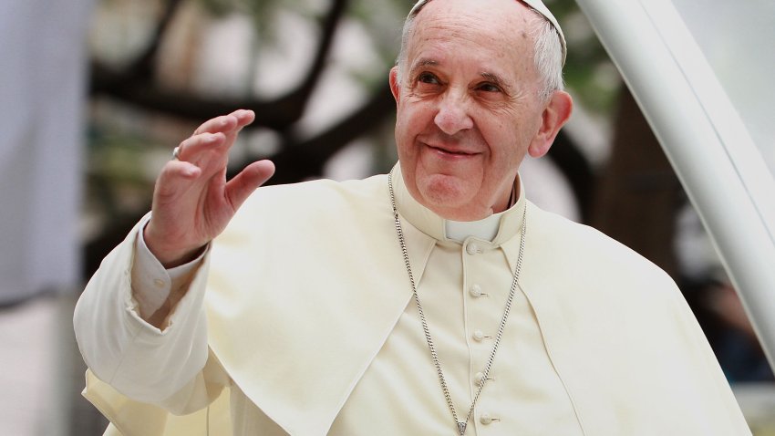 Pope Francis waves to thousands of followers as he arrives at the Manila Cathedral on January 16, 2015 in Manila, Philippines.