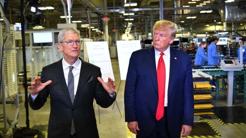 US President Donald Trump (r) and Apple CEO Tim Cook speak to the press during a tour of the Flextronics computer manufacturing facility where Apple’s Mac Pros are assembled in Austin, Texas, on November 20, 2019.