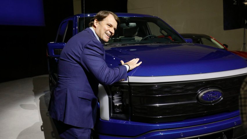 Ford CEO Jim Farley pats a Ford F-150 Lightning truck on February 13, 2023 in Romulus, Michigan.