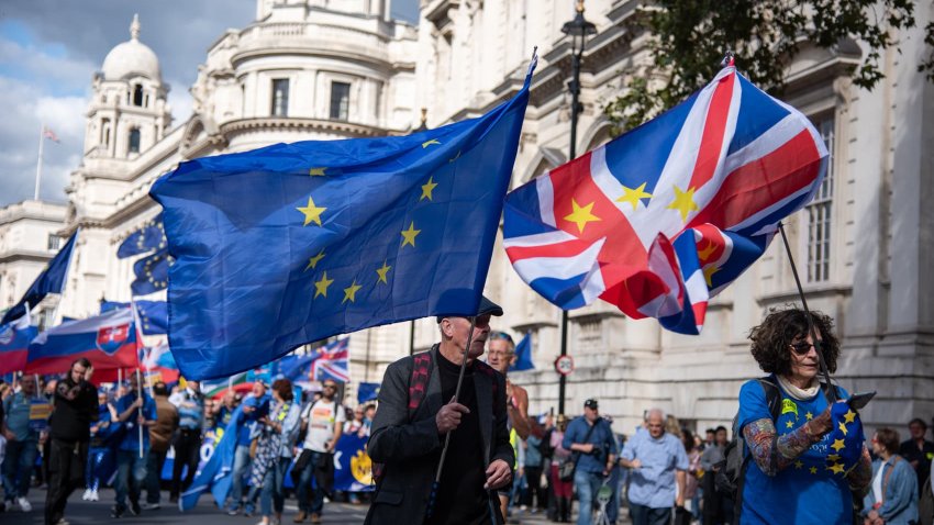 Protestors march with large flags during The National Rejoin March. Pro-EU groups demonstrated in central London, UK.