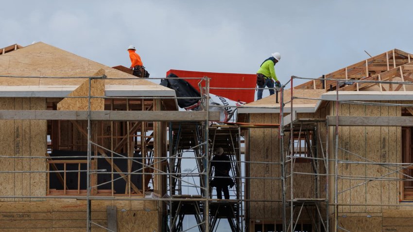 Construction workers use wood and lumber to build residential homes in Irvine, California, U.S., March 28, 2025. 