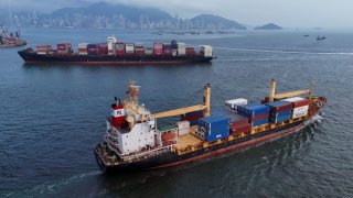 Vessels carrying shipping containers sail near Kwai Tsing Container Terminal in Hong Kong, China, April 23, 2025.
