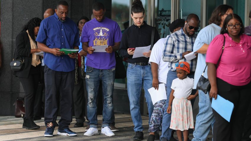 People line up as they wait for the Mega JobNewsUSA South Florida Job Fair to open at the Amerant Bank Arena on April 30, 2025 in Sunrise, Florida.