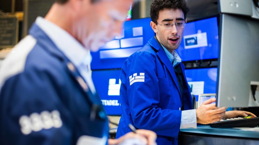 Traders work on the floor of the New York Stock Exchange on May 1, 2025.