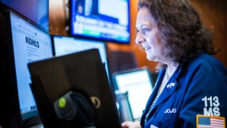Traders work on the floor of the New York Stock Exchange on May 1, 2025.