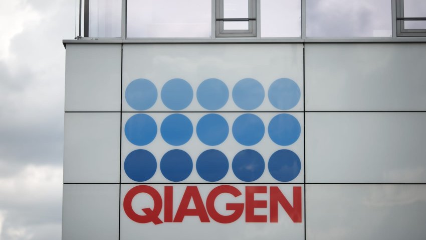 FILE PHOTO: The logo of Qiagen NV sits on the exterior of the company’s headquarters in Hilden, Germany, on Friday, Aug. 22, 2014.