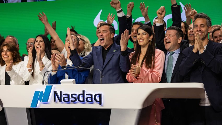 Yoni Assia, co-founder and chief executive officer of EToro Group Ltd., center, and Ronen Assia, co-founder of EToro Group Ltd., center left, ring the opening bell during the company’s initial public offering at the Nasdaq MarketSite in New York, US, on Thursday, May 15, 2025.