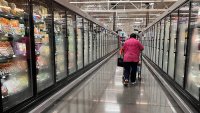 A woman walks in an aisle of a Walmart supermarket in Houston, Texas, on May 15, 2025.