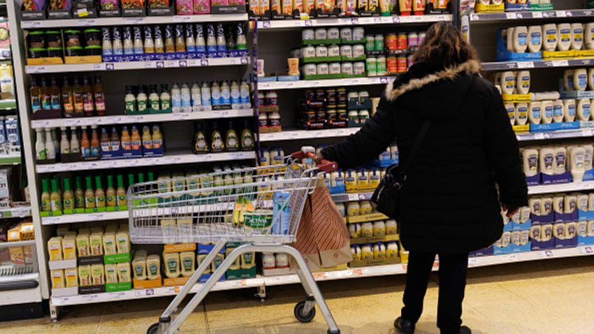 A customer looks at goods on a shelf in a supermarket on January 15, 2025 in London, England.