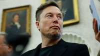 Elon Musk listens as reporters ask U.S. President Donald Trump and South Africa President Cyril Ramaphosa questions during a press availability in the Oval Office at the White House on May 21, 2025 in Washington, DC.