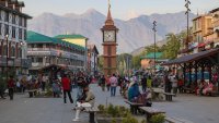 Indian tourists and Kashmiris walk near the clock tower (Ghanta Ghar) in Srinagar, Jammu and Kashmir, on May 28, 2025.