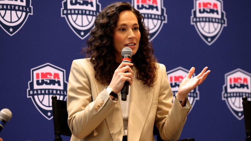 Sue Bird speaks into a microphone at a press conference