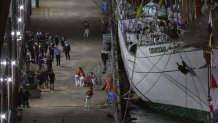 Sailors on the Cuauhtémoc, a masted Mexican Navy training ship, disembark at Pier 35 after the ship collided with the Brooklyn Bridge, Saturday, May 17, 2025, in New York. (AP Photo/Yuki Iwamura)