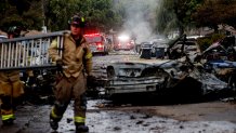 Firefighters are working on the place where a small plane collapsed on May 22, 2025 on a street in San Diego, California. The neighborhood is located near the Montgomery Gibbs Executive Airport. The crash left a "Gigantic rubble field" And damage around 15 houses and parked cars, ABC News quoted the deputy fire chief of San Diego. (Photo by Sandy Huffaker / AFP) (Photo by Sandy Huffaker / AFP via Getty Images)