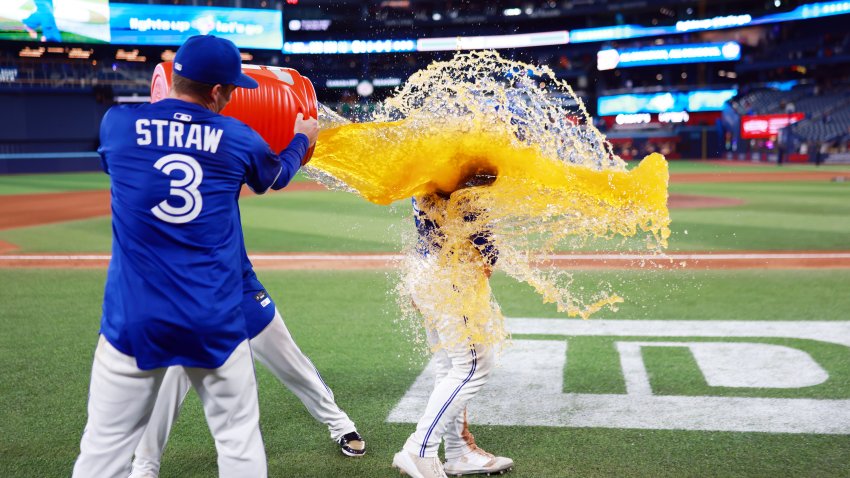 TORONTO, ON – MAY 22:  Vladimir Guerrero Jr. #27 and Myles Straw #3 of the Toronto Blue Jays douse Daulton Varsho #5 with Gatorade after a walk off win against the San Diego Padres at Rogers Centre on May 22, 2025 in Toronto, Ontario, Canada.  (Photo by Vaughn Ridley/Getty Images)
