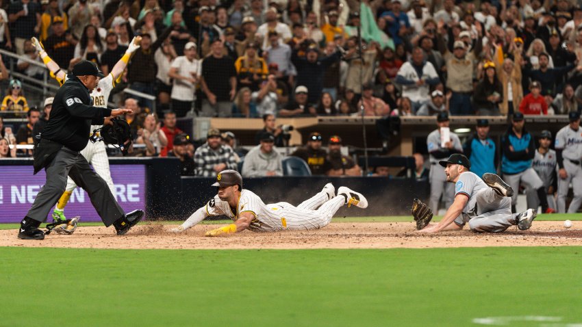 SAN DIEGO, CALIFORNIA – MAY 26: Tyler Wade #14 of the San Diego Padres slides into home plate scoring the walk-off run in the eleventh inning of the game against the Miami Marlins at Petco Park on May 26, 2025 in San Diego, California. (Photo by Matt Thomas/San Diego Padres/Getty Images)