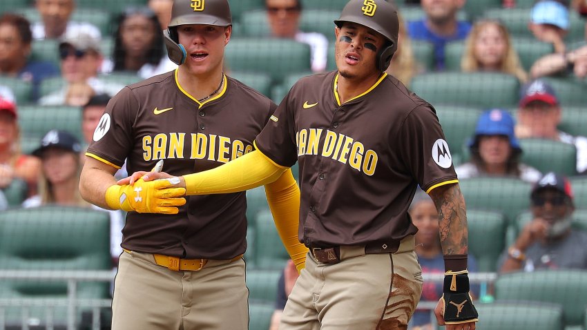 ATLANTA, GEORGIA – MAY 25:  Manny Machado #13 of the San Diego Padres reacts with Gavin Sheets #30 after scoring on a RBI single by Jackson Merrill #3 in the first inning against the Atlanta Braves at Truist Park on May 25, 2025 in Atlanta, Georgia. (Photo by Kevin C. Cox/Getty Images)