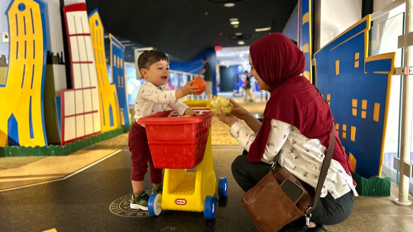 Asmas Quzz plays with her young son, Amin, at the Fleet Science Center, Saturday. May 10, 2025.