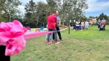 The parents of Sophie Jones joined Encinitas Mayor Bruce Ehlers in cutting the ribbon for the new playground.