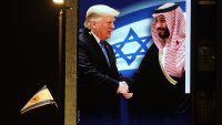 A billboard bearing a picture depicting President Donald Trump shaking hands with Saudi Crown Prince Mohammed bin Salman with the slogan above: "history won't wait" is displayed by the Coalition for Regional Security group on the facade of a hotel building in Jerusalem on May 12, 2025.