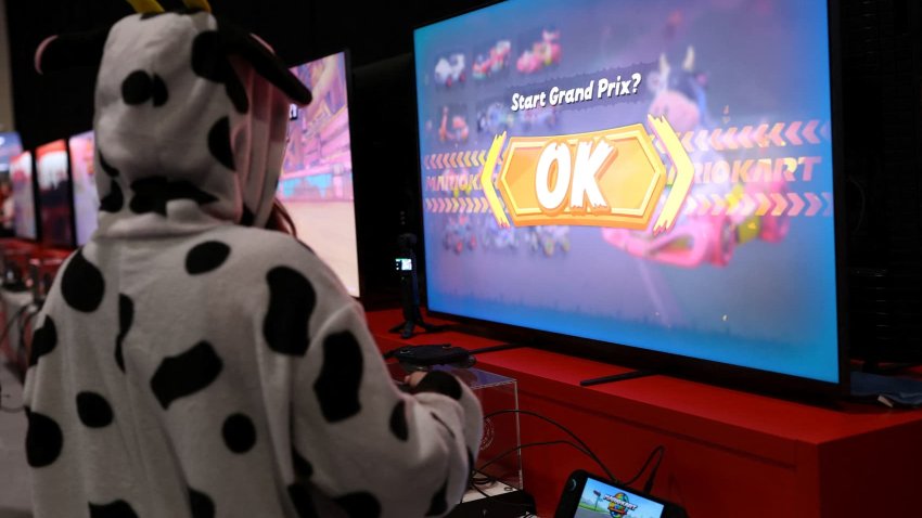 An attendee wearing a cow costume while playing Mario Kart World by Nintendo Switch 2 during the Nintendo Switch 2 Experience at the ExCeL London international exhibition and convention centre in London, Britain, April 11, 2025. 