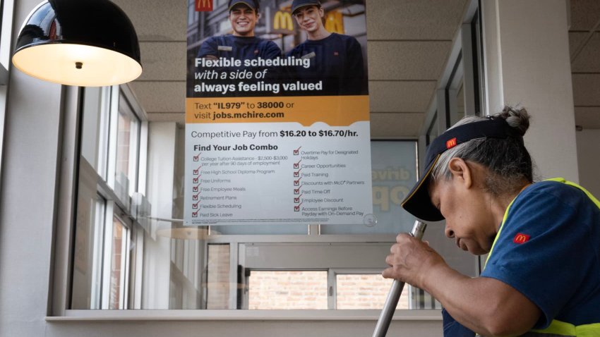 A sign promoting the benefits of working for McDonald’s hangs in the window of a restaurant on May 13, 2025 in Chicago, Illinois.