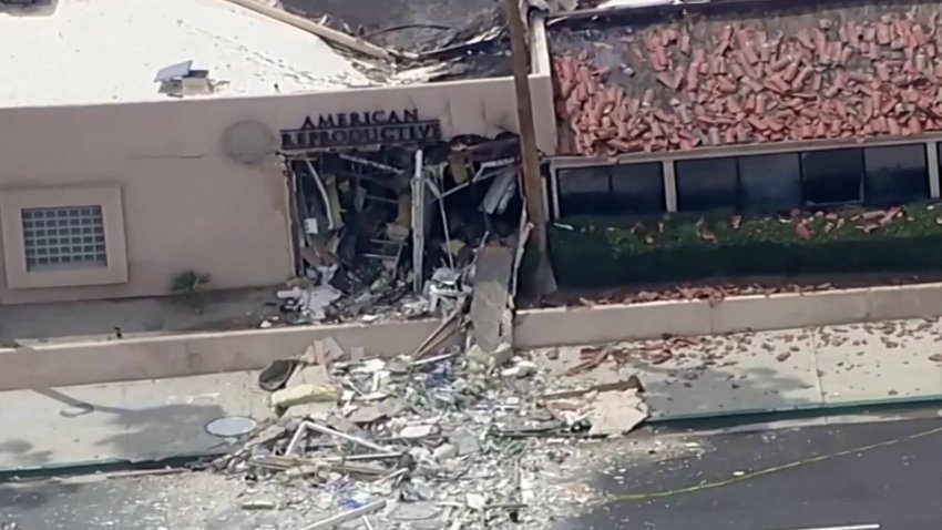 Debris is spilled onto the street after what the Mayor described as a bomb exploded near a reproductive health facility in Palm Springs, California, on May 17, 2025, in a still image from video.