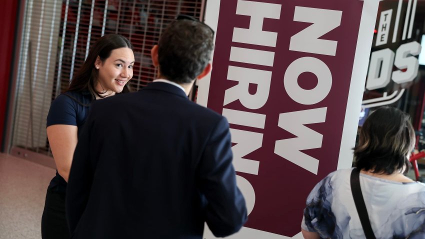 =Kiaraliz Irizarry (L) recruits people for jobs at Triton Recovery during the Mega JobNewsUSA South Florida Job Fair held in the Amerant Bank Arena on April 30, 2025 in Sunrise, Florida.