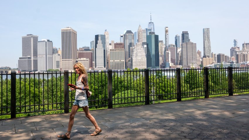People enjoy an unusually warm day in New York City as temperatures reach the low 80s on June 4, 2025 in New York City.