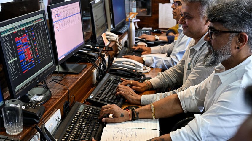 Stock traders monitor share prices during an intra-day trading session at a brokerage house in Mumbai on April 8, 2025. Asian and European markets battled on April 8 to recover from the previous day’s tariff-fuelled collapse. US President Donald Trump slapped a flat 26 percent tariff on imports from India last week, with New Delhi saying it was examining both “implications” and “opportunities” from the duty hikes. (Photo by Indranil MUKHERJEE / AFP) (Photo by INDRANIL MUKHERJEE/AFP via Getty Images)