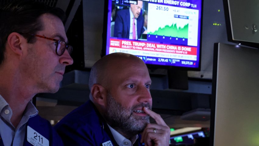 Traders work on the floor at the New York Stock Exchange (NYSE) in New York City, U.S., June 11, 2025.