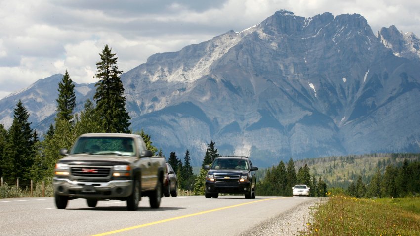 Vehicles drive along the Trans Canada Highway through Banff National Park with Mt. Cascade in the background. Prime Minister Stephen Harper announced the further twinning of the Trans Canada Highway through Banff National Park on Tuesday, Aug. 5, 2008.