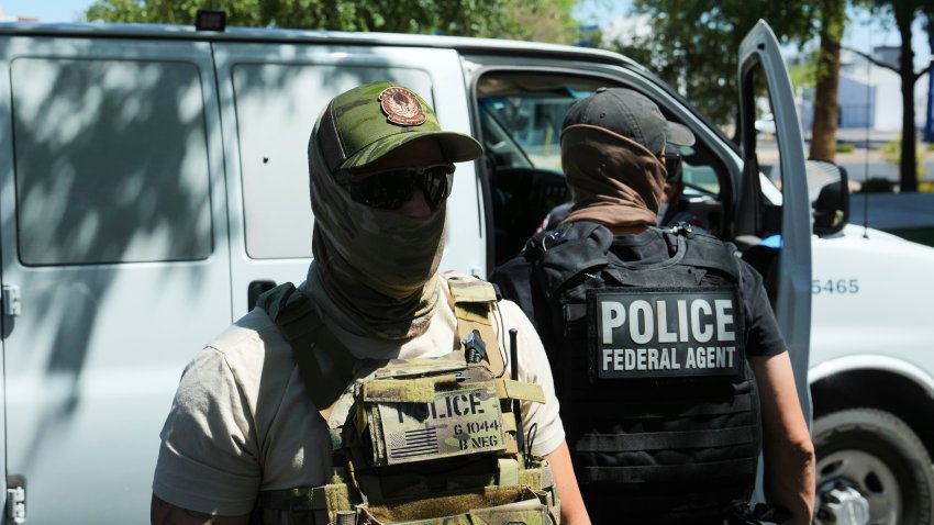 File - ICE and Homeland Security Investigations police make an arrest outside an immigration court in Phoenix on May 21.