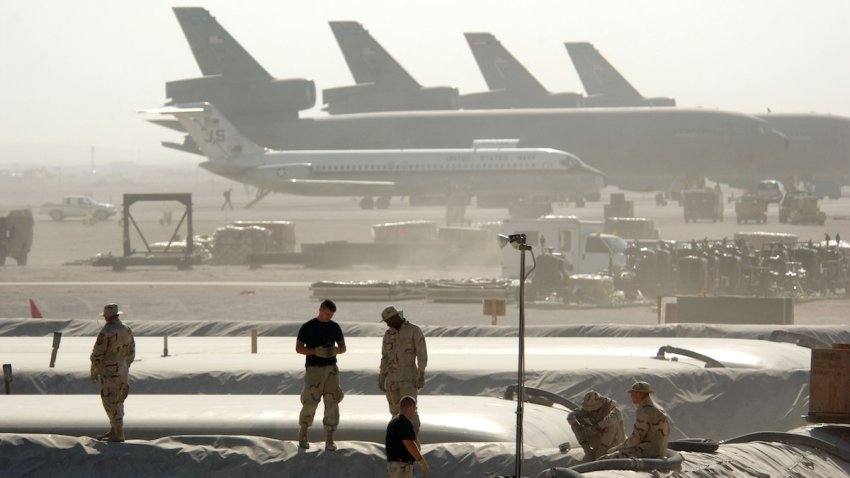 Members of the Petroleum Oils and Lubricants (POL) squadron at the 379th Air Expeditionary Wing take a break from replacing a 50,000-gallon fuel bladder in support of Operation Enduring Freedom Dec. 30, 2002 in Al Udeid, Qatar.