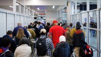 Travelers stand in line for security screening at Hartsfield-Jackson Atlanta International Airport