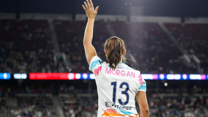 SAN DIEGO, CALIFORNIA – SEPTEMBER 08: Alex Morgan #13 of San Diego Wave FC waves to fans after the game against North Carolina Courage at Snapdragon Stadium on September 08, 2024 in San Diego, California. Morgan bid farewell to fans and fellow athletes after announcing her retirement from the game three days earlier, marking this game as her last. (Photo by Meg Oliphant/Getty Images)