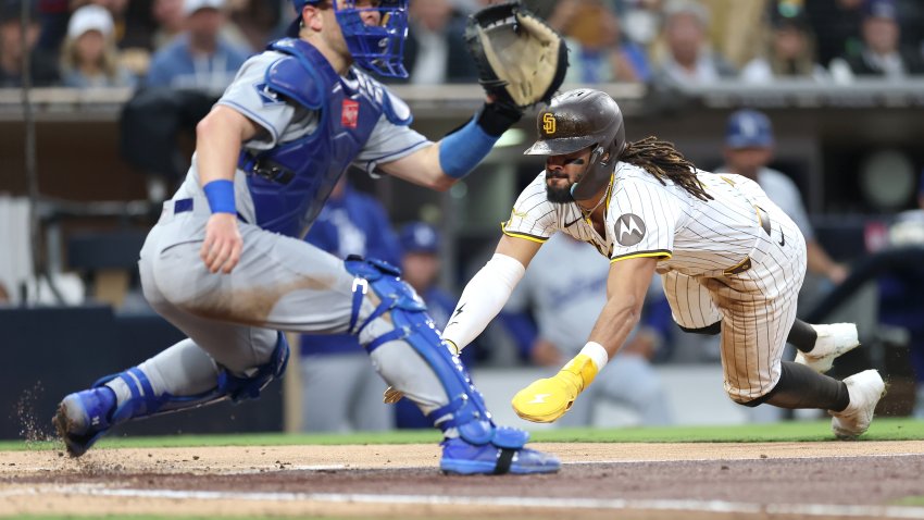 SAN DIEGO, CALIFORNIA – JUNE 10: Fernando Tatis Jr. #23 scores on an RBI double hit by Luis Arraez #4 of the San Diego Padres as Dalton Rushing #68 of the Los Angeles Dodgers is late with the tag during the third inning of a game against the Los Angeles Dodgers at Petco Park on June 10, 2025 in San Diego, California. (Photo by Sean M. Haffey/Getty Images)