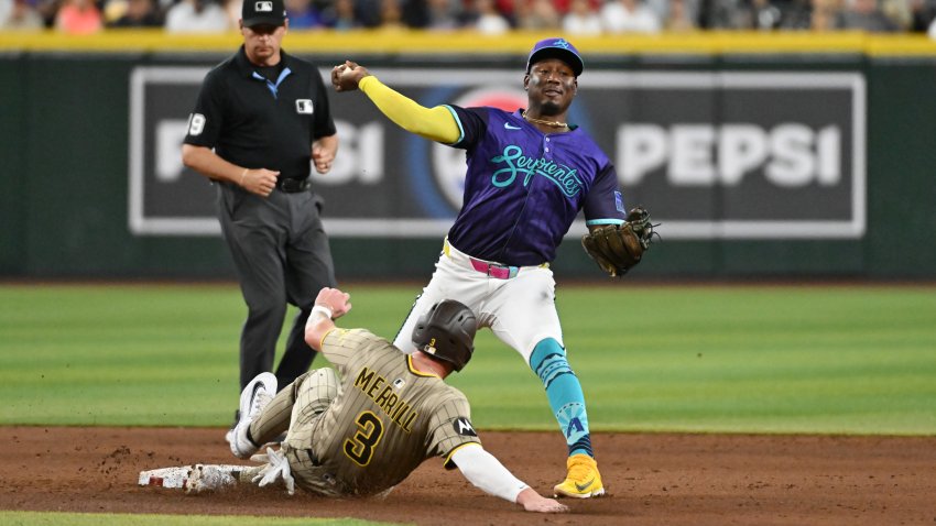 PHOENIX, ARIZONA – JUNE 13: Geraldo Perdomo #2 of the Arizona Diamondbacks turns a double play on a ground ball hit by Gavin Sheets #30 of the San Diego Padres as Jackson Merrill #3 is forced out at second base during the sixth inning at Chase Field on June 13, 2025 in Phoenix, Arizona. (Photo by Norm Hall/Getty Images)
